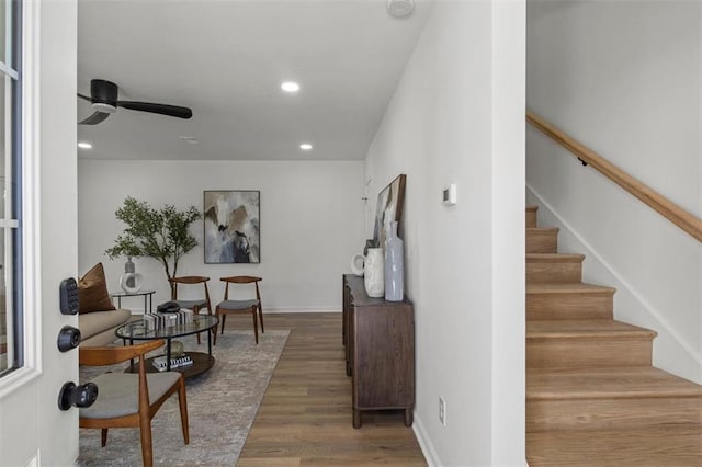interior space with wood finished floors, stairs, baseboards, ceiling fan, and recessed lighting