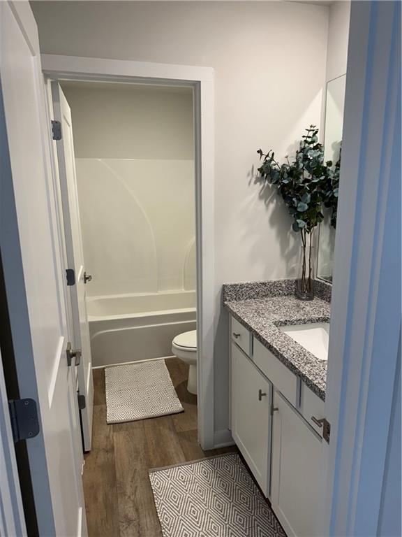 719 Windstream Dr, Lagrange, GA 30241 - bathroom featuring toilet, vanity, and wood finished floors