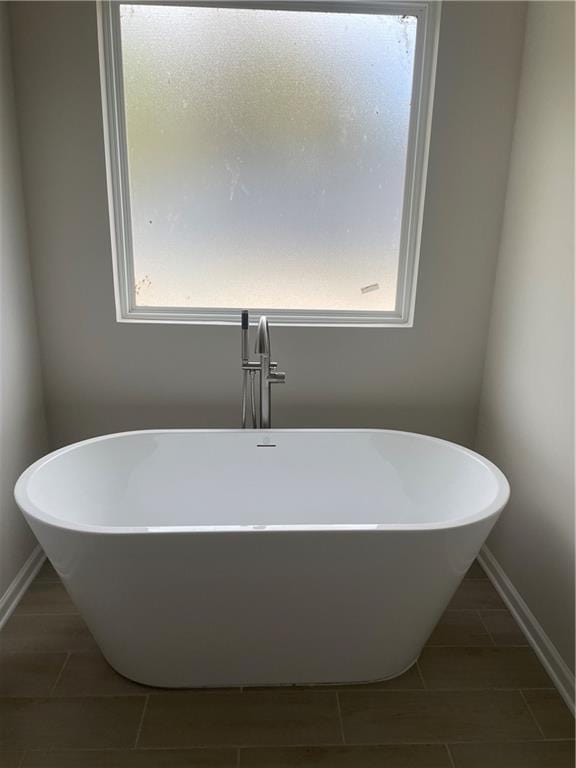 719 Windstream Dr, Lagrange, GA 30241 - bathroom with plenty of natural light, a freestanding bath, and tile patterned floors