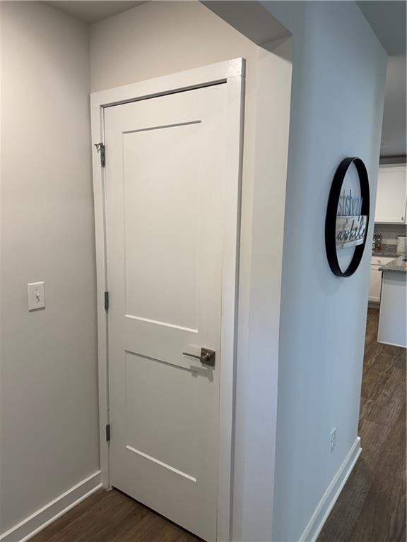 719 Windstream Dr, Lagrange, GA 30241 - hall with dark wood-style flooring and baseboards