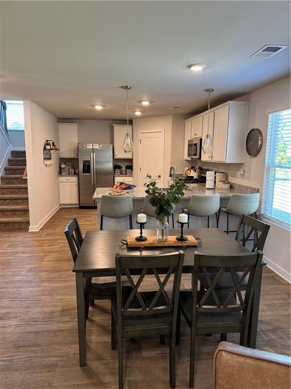 719 Windstream Dr, Lagrange, GA 30241 - dining room with baseboards, stairs, wood finished floors, and recessed lighting