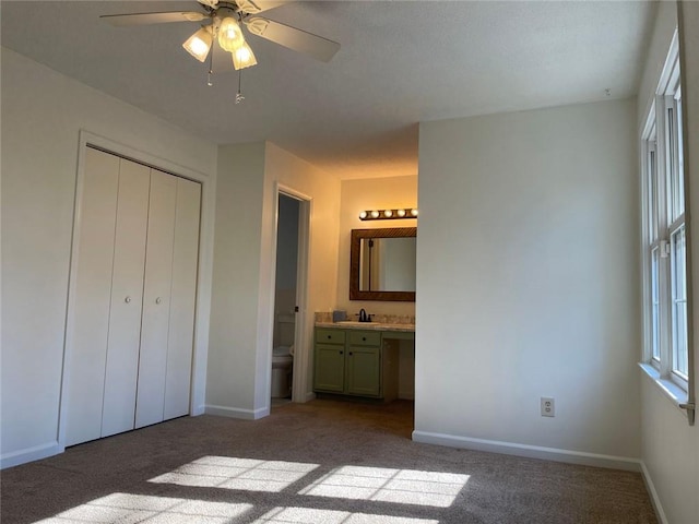 unfurnished bedroom with carpet floors, a closet, and baseboards