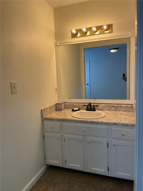 bathroom with vanity and baseboards