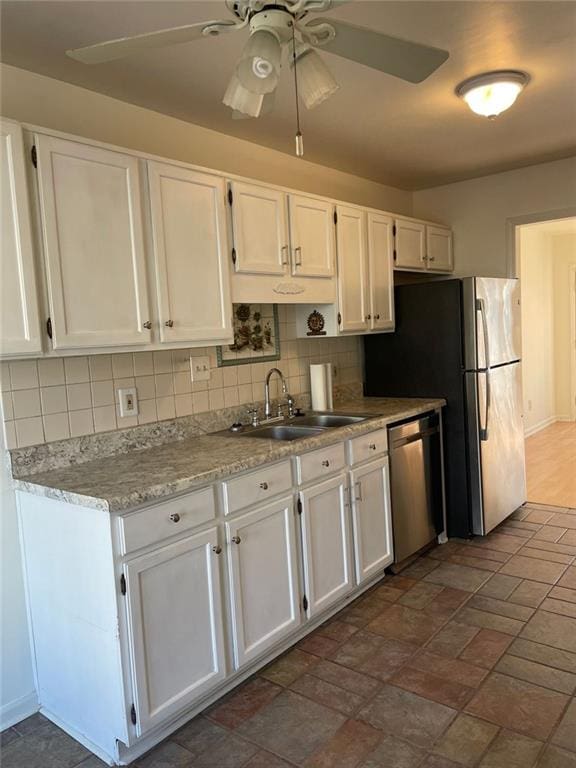 kitchen featuring backsplash, a ceiling fan, white cabinetry, a sink, and dishwasher