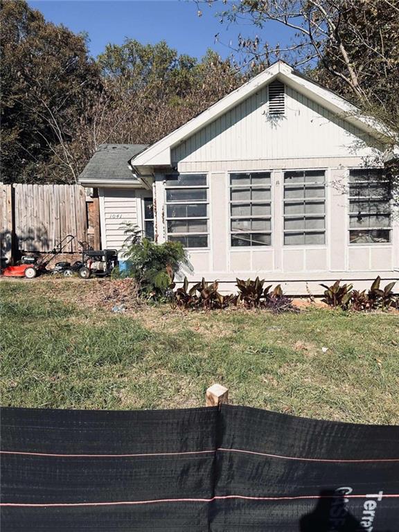 view of side of home with a lawn