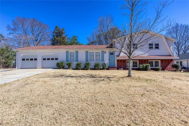 view of front of home featuring a garage, a front yard, concrete driveway, and brick siding