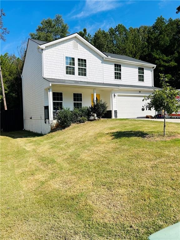 view of front property featuring a front yard and a garage