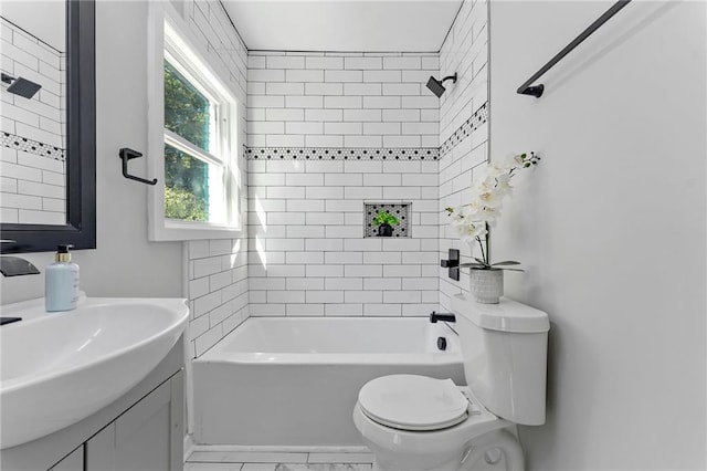 full bath with toilet, marble finish floor, a sink, and shower / bathing tub combination