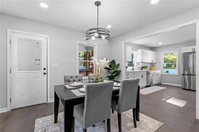 dining room featuring baseboards, dark wood finished floors, and recessed lighting