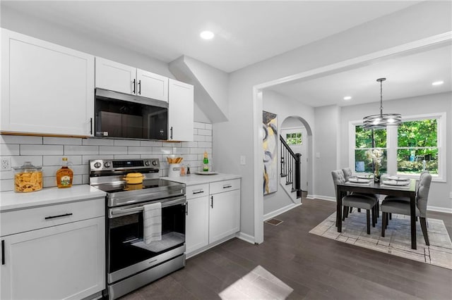 kitchen with dark wood-style floors, light countertops, decorative backsplash, white cabinetry, and stainless steel electric range