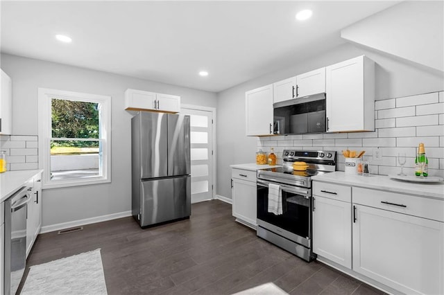 kitchen with stainless steel appliances, dark wood-type flooring, light countertops, and white cabinetry