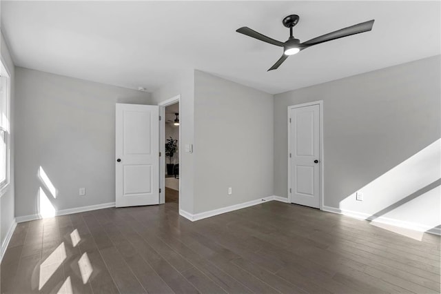 interior space with baseboards and dark wood-style flooring