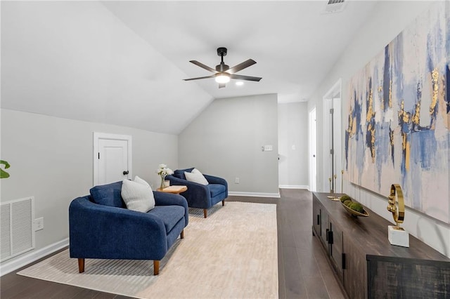 living area with visible vents, vaulted ceiling, baseboards, and wood finished floors