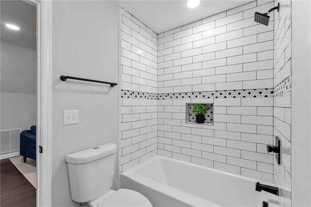 bathroom with toilet, bathtub / shower combination, visible vents, and wood finished floors