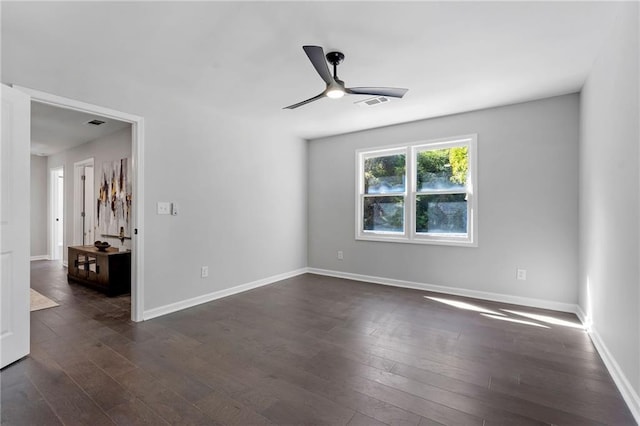 unfurnished room featuring ceiling fan, visible vents, baseboards, and dark wood-type flooring