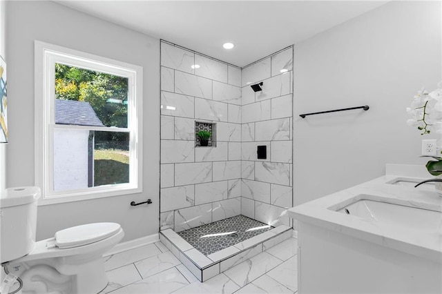 full bathroom with marble finish floor, toilet, a stall shower, a sink, and baseboards