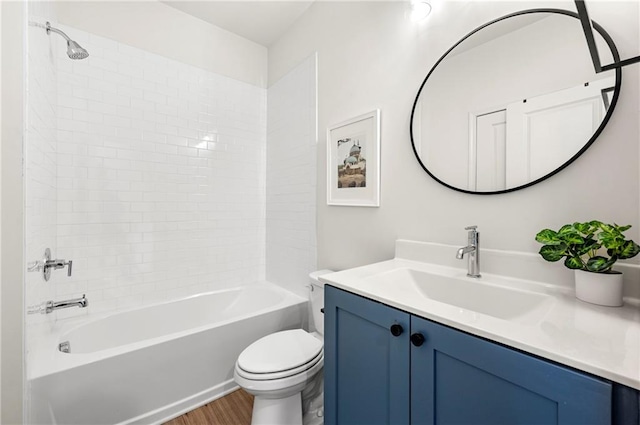 bathroom featuring toilet, vanity, bathing tub / shower combination, and wood finished floors