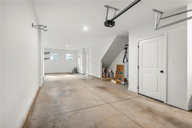 garage featuring a garage door opener and baseboards