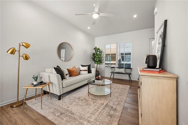 living room with a ceiling fan, wood finished floors, baseboards, lofted ceiling, and recessed lighting