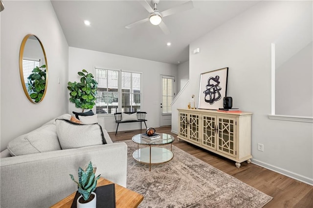 living room with hardwood / wood-style floors, vaulted ceiling, and ceiling fan