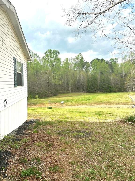 view of yard featuring a wooded view