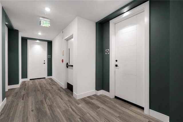 foyer entrance featuring baseboards, recessed lighting, and wood finished floors