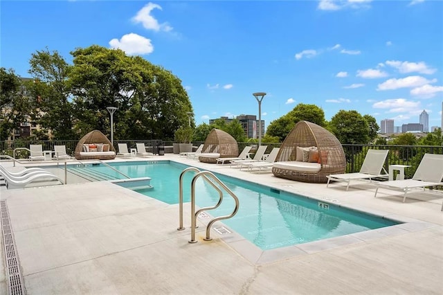 community pool featuring a patio and fence