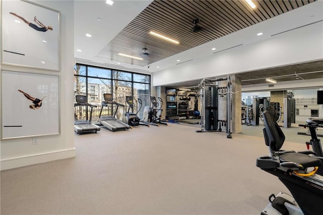 workout area with a wall of windows and carpet