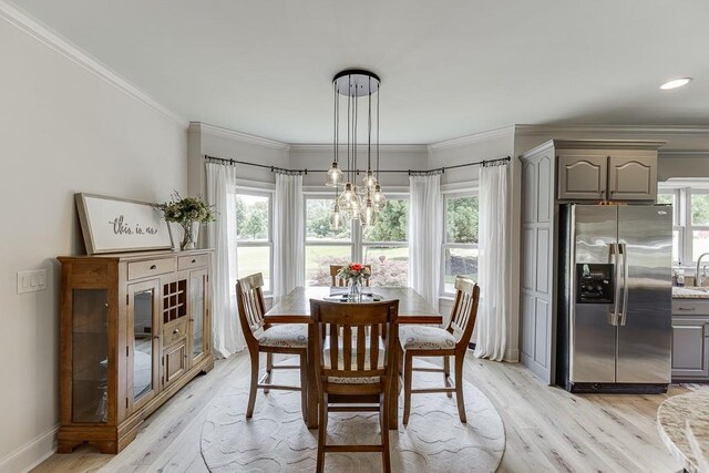 2623 Lindsey Grace Ln, Buford, GA 30519 - dining area featuring light wood-style floors, a chandelier, ornamental molding, and baseboards