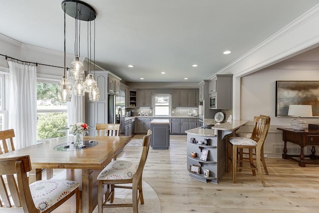 2623 Lindsey Grace Ln, Buford, GA 30519 - dining space featuring crown molding, light wood finished floors, and recessed lighting
