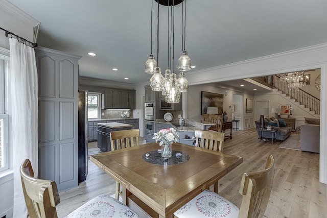 2623 Lindsey Grace Ln, Buford, GA 30519 - dining space featuring ornamental molding, a chandelier, stairs, light wood-type flooring, and recessed lighting