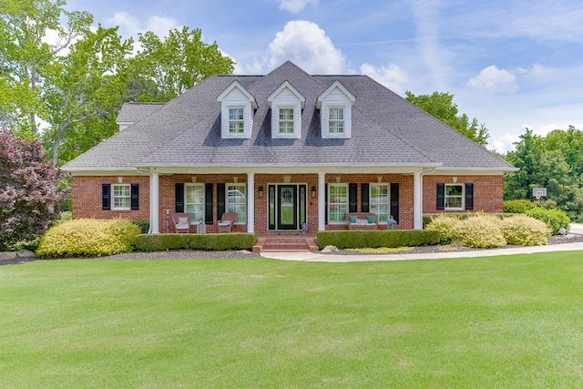 2623 Lindsey Grace Ln, Buford, GA 30519 - cape cod-style house with covered porch, a front yard, and brick siding