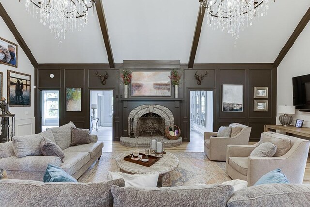 2623 Lindsey Grace Ln, Buford, GA 30519 - living area with a chandelier, a decorative wall, high vaulted ceiling, a brick fireplace, and light wood-type flooring