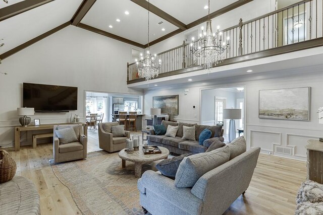 2623 Lindsey Grace Ln, Buford, GA 30519 - living room featuring high vaulted ceiling, a decorative wall, light wood-type flooring, a chandelier, and beamed ceiling