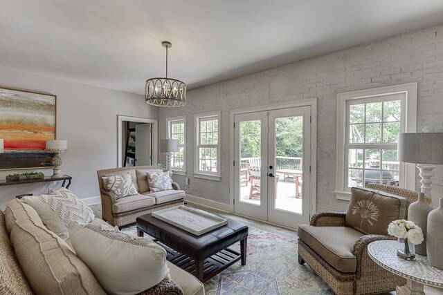 2623 Lindsey Grace Ln, Buford, GA 30519 - living area with french doors, a chandelier, baseboards, and wood finished floors