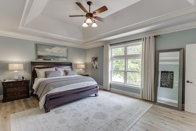 2623 Lindsey Grace Ln, Buford, GA 30519 - bedroom featuring light wood finished floors, crown molding, baseboards, and a raised ceiling