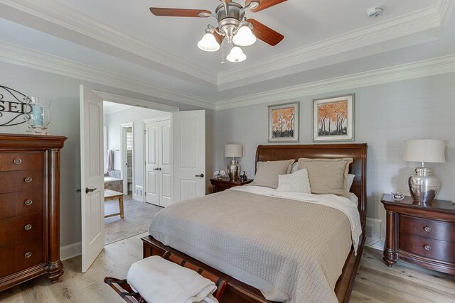 2623 Lindsey Grace Ln, Buford, GA 30519 - bedroom featuring light wood-style floors, a tray ceiling, ornamental molding, and ceiling fan