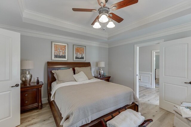2623 Lindsey Grace Ln, Buford, GA 30519 - bedroom with light wood finished floors, a tray ceiling, ornamental molding, and ceiling fan
