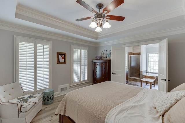 2623 Lindsey Grace Ln, Buford, GA 30519 - bedroom featuring a tray ceiling, crown molding, light wood-style floors, and a ceiling fan