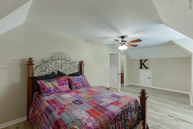 2623 Lindsey Grace Ln, Buford, GA 30519 - bedroom with vaulted ceiling, light wood-style floors, a ceiling fan, and baseboards
