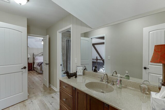 2623 Lindsey Grace Ln, Buford, GA 30519 - ensuite bathroom featuring wood finished floors, vanity, a ceiling fan, a shower with shower curtain, and baseboards