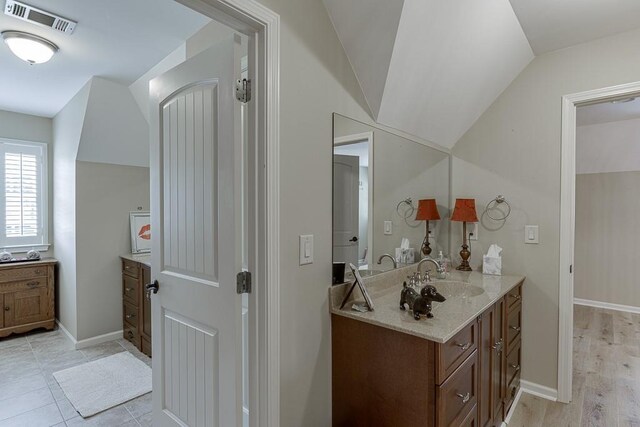 2623 Lindsey Grace Ln, Buford, GA 30519 - bathroom featuring vanity, lofted ceiling, and baseboards