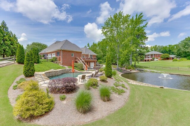 2623 Lindsey Grace Ln, Buford, GA 30519 - view of yard with stairway, a deck with water view, a patio area, and an attached garage