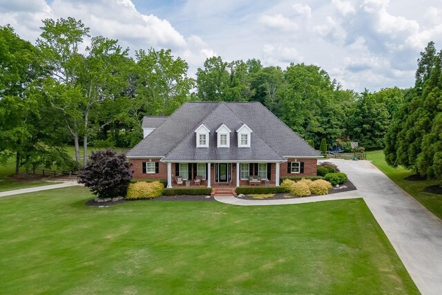 2623 Lindsey Grace Ln, Buford, GA 30519 - cape cod house featuring brick siding, a porch, and a front yard