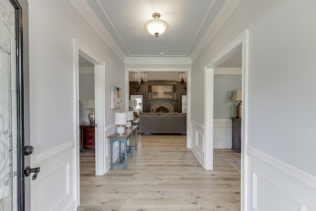 2623 Lindsey Grace Ln, Buford, GA 30519 - entrance foyer featuring light wood-style floors, a wainscoted wall, crown molding, and a fireplace