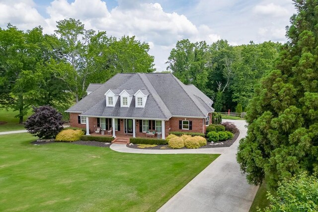 2623 Lindsey Grace Ln, Buford, GA 30519 - cape cod-style house featuring brick siding, covered porch, and a front lawn