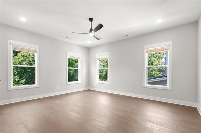 unfurnished room with a ceiling fan, recessed lighting, dark wood-style flooring, and baseboards