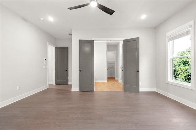 unfurnished bedroom featuring recessed lighting, ceiling fan, baseboards, and wood finished floors