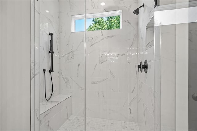 bathroom with a marble finish shower