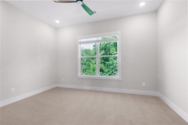 unfurnished room featuring ceiling fan, recessed lighting, light colored carpet, and baseboards